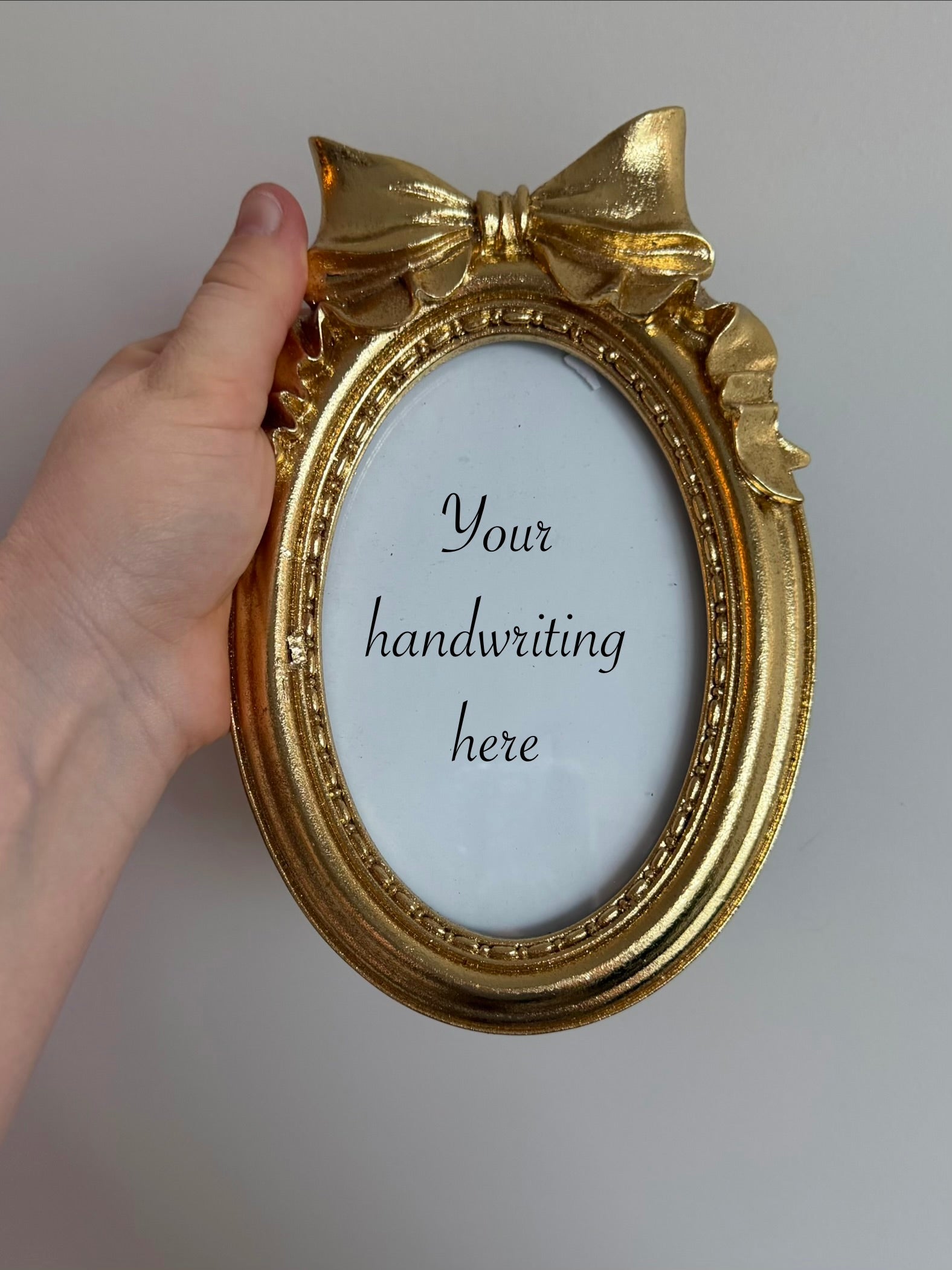 Gold oval frame with bow - 6 x 4 inch opening